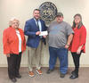 County supervisors Shelbie Willis, Josh Evans and Peggy Kiser present a donation to DC Shining Stars.  PROVIDED BY COUNTY